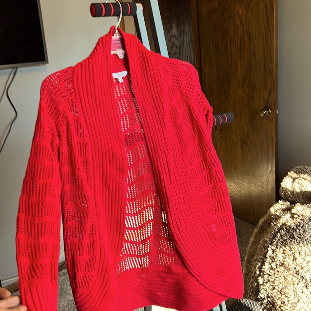 A brand new Long warm red cardigan. It cover your arms , body, and butt.
